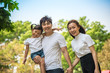 © tuastockphoto - Portrait Of Happy Asian Family In Garden