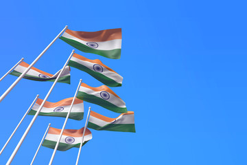 Wall Mural - India flags waving in the wind against a blue sky. 3D Rendering