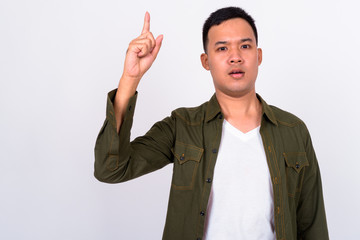 Poster - Portrait of young Asian man pointing up