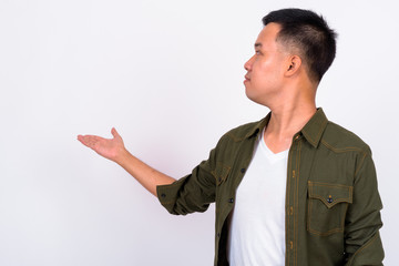 Wall Mural - Portrait of young Asian man showing to the back