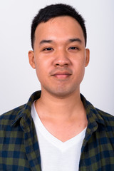Wall Mural - Face of young Asian hipster man looking at camera