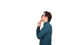 Side View Of Young Businessman Keeps Hand Under Chin, Thoughtful Gesture, Isolated Over White Background With Copy Space. Business Worker Wears Glasses Looking Ahead Focused, Thinking Of Great Ideas.