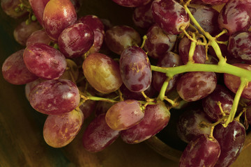 Grape and wooden plate and background