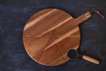 Pizza serving board and knife for pizza. Food concept background. View from above, top studio shot