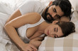 © Goran - Young couple sleeping embraced in bed