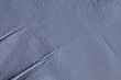 Background of natural gray pigskin with folds. Genuine leather is used for tailoring fashionable comfortable outerwear, shoes and accessories.