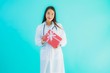 © siraphol - Portrait beautiful young asian doctor woman with gift box