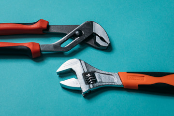 Wall Mural - metal pliers of metal on a blue background laid neatly close