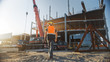 © Gorodenkoff - Back Shot of Worker Contractor Wearing Hard Hat and Safety Vests Walks on Industrial Building Construction Site. In the Background Crane, Skyscraper Concrete Formwork Frames