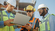 © Gorodenkoff - Diverse Team of Specialists Use Laptop Computer on Construction Site. Real Estate Building Project with Civil Engineer, Architectural Investor, Businesswoman and Worker Discussing Blueprint Plan