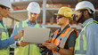 © Gorodenkoff - Diverse Team of Specialists Use Laptop Computer on Construction Site. Real Estate Building Project with Civil Engineer, Architectural Investor, Businesswoman and Worker Discussing Blueprint Plan