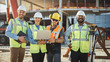 © Gorodenkoff - Diverse Team of Specialists Use Laptop Computer on Construction Site. Real Estate Building Project with Machinery: Civil Engineer, Investor, Businesswoman and Builder Discussing Blueprint Plan