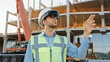 © Gorodenkoff - Futuristic Architectural Engineer Wearing Augmented Reality Headset and Using Gestures to Control Commercial Building Construction Site. In Background Skyscraper Formwork Frames and Industrial Crane