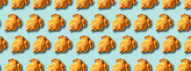 Wall Mural - colorful pattern of roasted chicken or turkey on blue background. top view. creative design for pack