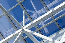 Steel Frame Of The Glazed Roof Of A Warehouse, Shopping Or Office Center. The Ceilings Are Made Of Metal Beams Interconnected By Bolts And Welding To Maintain Mobility And Rigidity.