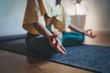 Home Yoga Flow, Closeup of young woman making mindfulness meditation at home sitting in lotus pose on yoga mat focus on feelings at the moment