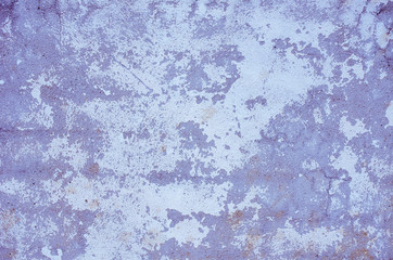 Fragment of old house wall close-up. Blue background. Peeling plaster on concrete surface. Cracks in paint. light blue tinted. Copy space. Place for text. Selective focus image. 