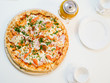 © SYARGEENKA - large view of pizza with bacon tomatoes and herbs.