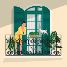 A Woman Stands On A Balcony Against A Panoramic Door With Shutters, And A Cat Walks Along The Railing.