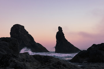 Wall Mural - Soft pink sunset and sea stacks at high tide along Bandon beach in Oregon