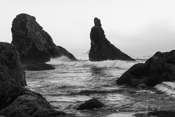 Wall Mural - Black and white image of waves splashing on sea stacks at Bandon beach in Oregon