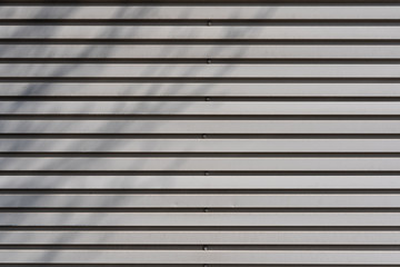 corrugated metal texture wall background with a repeating horizontal line pattern