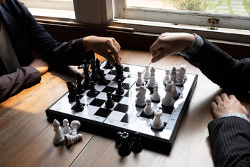 Business women play chess on board with white background, challenges planning business strategy to success concept