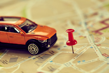 Wall Mural - travel concept - small toy car on the map