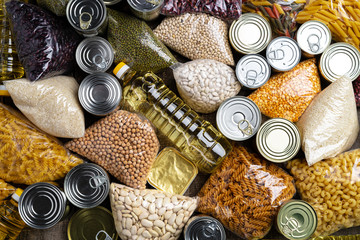 Donations food with canned food on the table background. Donate concept. Close up.