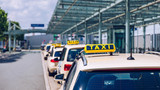 Fototapeta  - Taxi sign on the roof of a vehicle. Taxi cars on the street waiting for passengers. Selective focused image. Waiting taxi cars in the city.