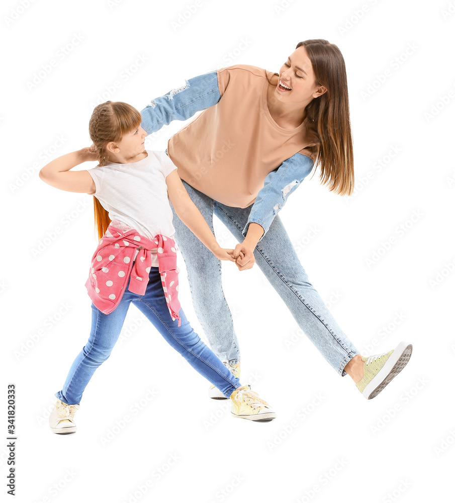 Happy mother and her little daughter dancing against white background