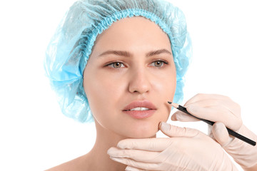 Sticker - Plastic surgeon applying marks on woman's face against white background