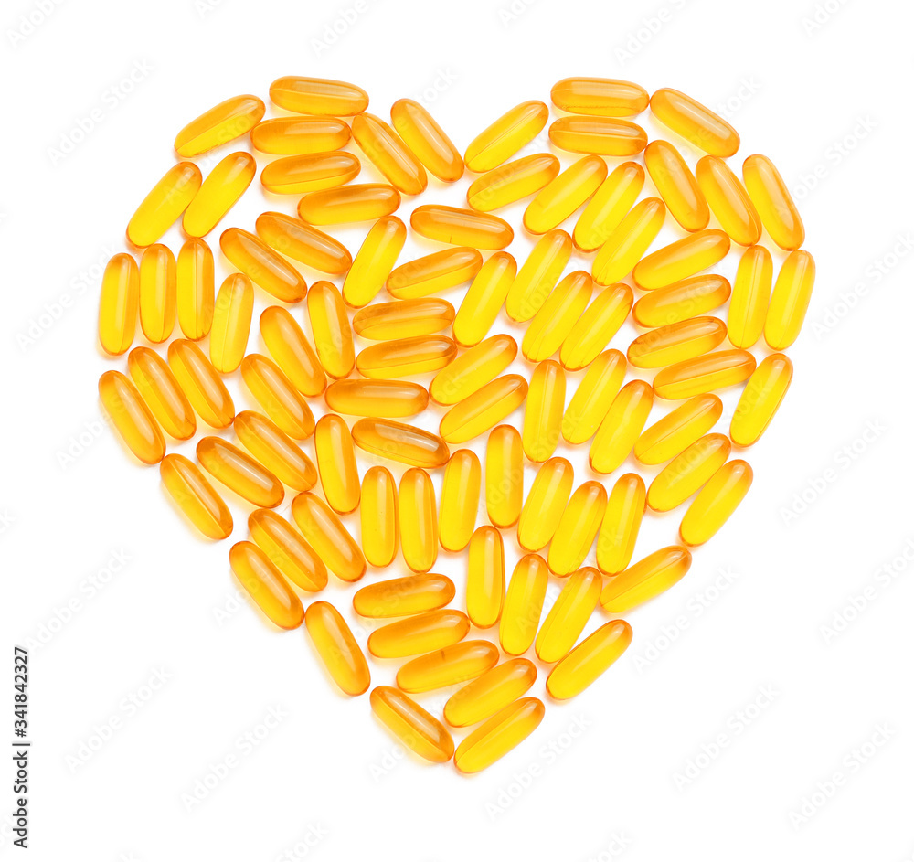 Heart made of fish oil capsules on white background