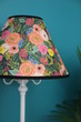 Floral colorful lampshade on a white lamp.
