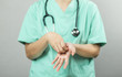 © eggeeggjiew - Nurse or Doctor in green uniform with stethoscope is demonstrating washing and cleaning hands and wrists