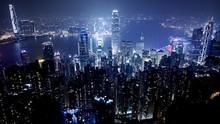 Illuminated Cityscape By Bay Against Sky