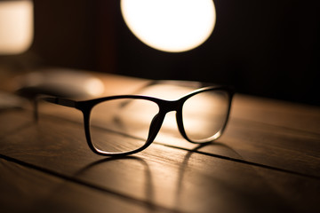 Glasses for sight and vision correction and protection from computer on the wooden table