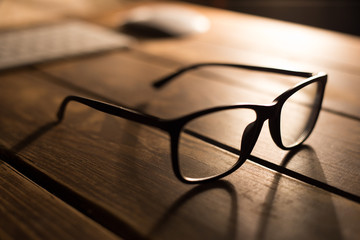 Glasses for sight and vision correction and protection from computer on the wooden table