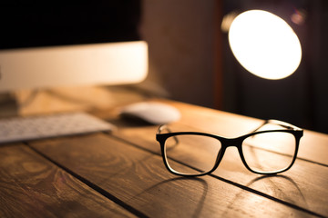 Sticker - glasses for sight and vision correction and protection from computer on the wooden table