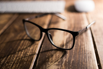 Glasses for sight and vision correction and protection from computer on the wooden table