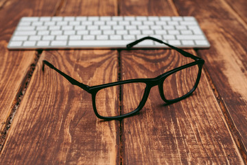 Poster - Glasses for sight and vision correction and protection from computer on the wooden table