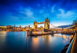 Fototapeta Londyn - Famous Tower Bridge over themes river London at night London, Aerial view to the illuminated Tower Bridge and skyline of London