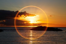 Idyllic Shot Of Sundog Over Sea Against Sky During Sunset