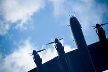 Low Angle View Of Military Airplane Flying Against Sky