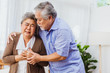 © Koto Amatsukami - Retired Asian senior elderly wife pain from heart attack disease or illness with serious or worried husband take care at home. Medical emrgency treatment and health care insurance protection concept