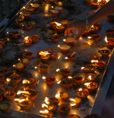 Hand reaching for devotional oil lamp, Hindu Kapaleeshwarar Temple, Chennai, Tamil Nadu, South India