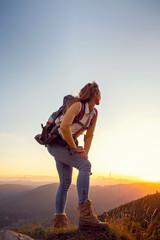 portrait of happy young woman hiking in the mountains