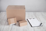 Fototapeta Lawenda - Cardboard boxes with clipboard on the desk. Products, Commerce, Retail, Delivery