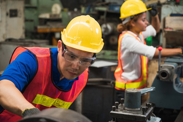 The industrial worker team is working on various projects in a large industrial factory with many equipment.