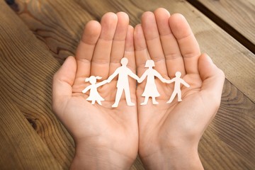 Poster - Paper chain family protected in cupped hands